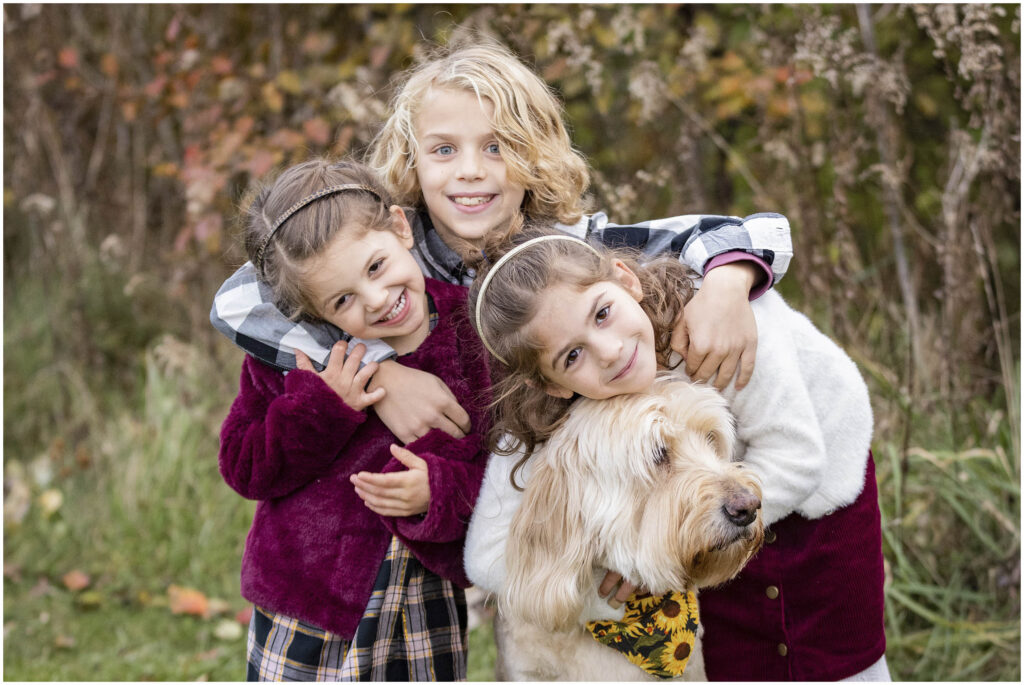 Kids hugging their dog