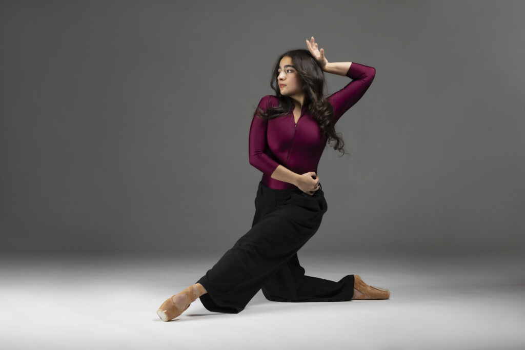 Dancer kneeling and pointing her toes